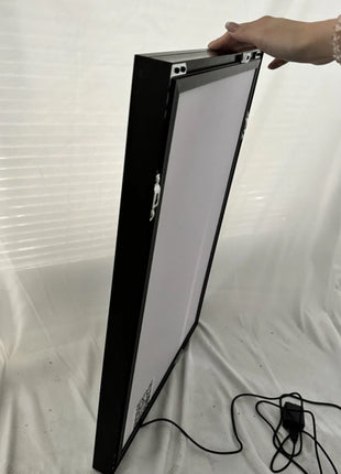  Side view of slim frame RGB LED acrylic lightbox being held to show its ultra-thin profile and lightweight design, perfect for art display, Snapping Turtle Gallery.