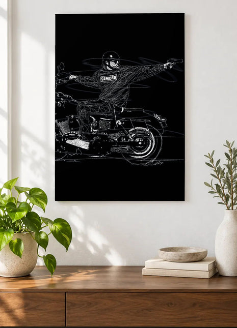 SAMCRO on Two Wheels acrylic wall art displayed above a wooden console with plants and books against a white wall.