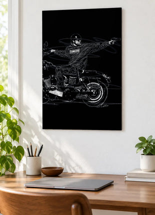 SAMCRO on Two Wheels acrylic wall art displayed above a wooden desk with a laptop, plants and books against a white wall.