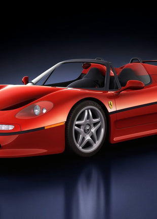 Red open-top Ferrari supercar with a tall rear wing and silver star-spoke wheels on a reflective dark blue-black studio floor.