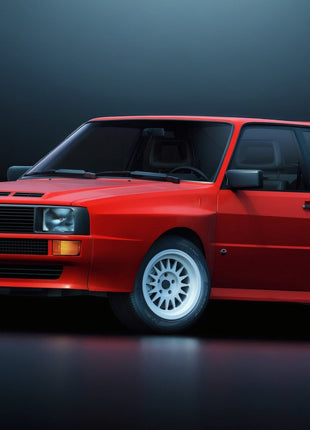 Red Audi rally-style coupe in front three-quarter view with squared headlamps, four-ring grille emblem and white multispoke wheels on a dark backdrop.
