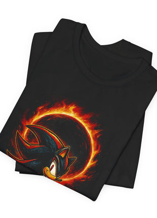 Folded black T-shirt detail showing Shadow’s red-striped quills and the glowing orange ring behind his head.