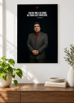 Silvio Dante Last Envelope acrylic wall art displayed above a wooden console with plants and books against a white wall.