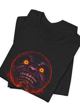 Folded black T-shirt detail showing the Majora’s Mask moon’s yellow eyes, purple shadows and bared teeth.