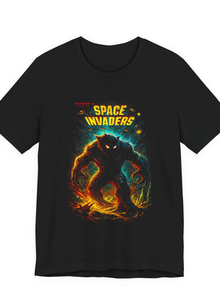 Black T-shirt front with yellow Space Invaders lettering and a dark glowing-eyed monster against cyan space.