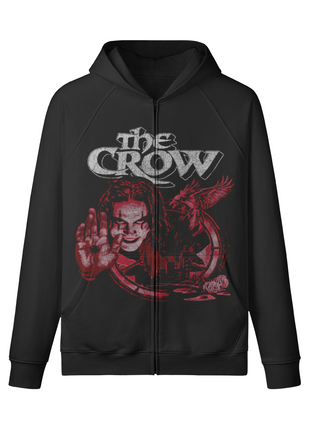 Front of a black The Crow Raised Hand zip-up hoodie with Eric Draven smiling behind an outstretched palm, a red crow and distressed gray title.