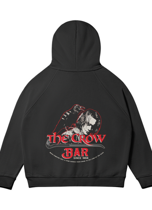 Rear view of The Crow Bar black hoodie with the hood raised above the red-and-cream Eric Draven and crow graphic.