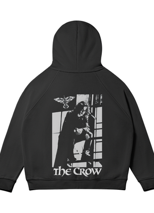 Rear view of The Crow Got Your Back hoodie with the hood raised and the black-and-white Eric Draven window scene centered on the back.