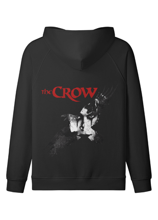 Back of the black The Crow Winged Shadow hoodie with the pale Eric Draven face, dark crow motif and red title lettering beneath the lowered hood.