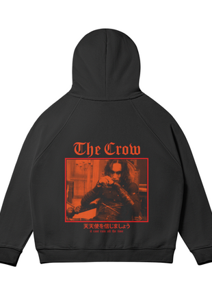 Rear view of the black The Crow Crimson Room hoodie with the hood raised, showing the red-orange seated Eric Draven scene and gothic title lettering across the back.