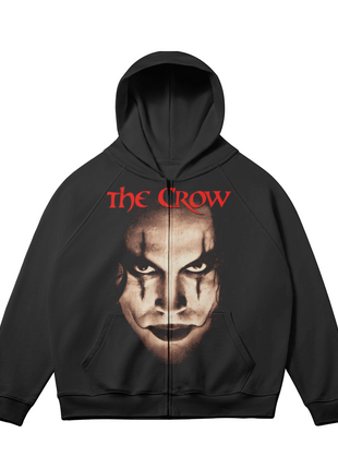 Alternate front view of the black The Crow Intense Gaze zip-up hoodie, with the sepia Eric Draven face portrait and red title lettering and sleeves angled outward.