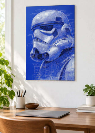 Stormtrooper Imperial Blueprints acrylic wall art displayed above a wooden desk with a laptop, plants and books against a white wall.