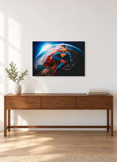 Superman A Moment Above Earth acrylic wall art displayed above a wooden console with a leafy vase and stacked books against a white wall.