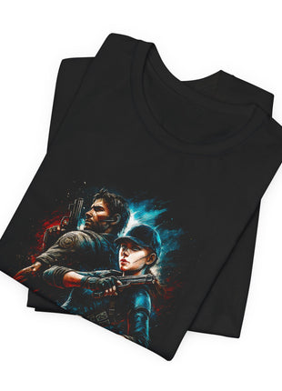Folded black T-shirt close-up showing the two tactical characters’ faces and handguns, with red and cyan accents.
