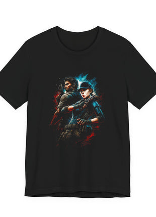 Front of black T-shirt showing a blue-capped tactical woman and an armed man back to back amid red and cyan brush strokes.