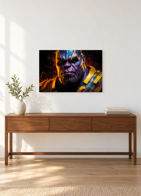Thanos Gilded Reckoning acrylic wall art displayed above a wooden console with a leafy vase and stacked books against a white wall.