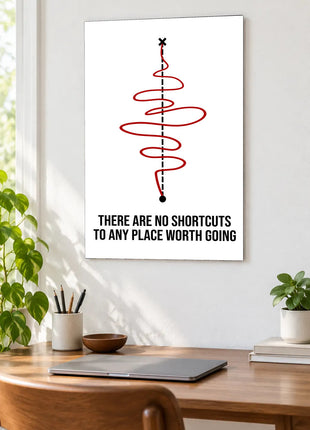 The Winding Way Forward acrylic wall art displayed above a wooden desk with a laptop, plants and books against a white wall.