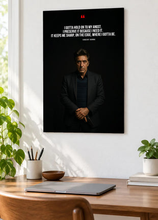 Vincent Hanna On the Edge acrylic wall art displayed above a wooden desk with a laptop, plants and books against a white wall.