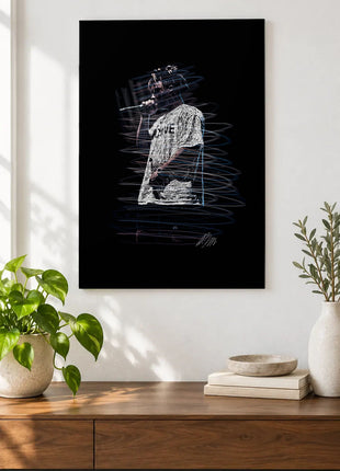Voice in the Gray Shirt acrylic wall art displayed above a wooden console with plants and books against a white wall.