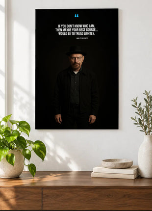 Walter White Tread Lightly acrylic wall art displayed above a wooden console with plants and books against a white wall.