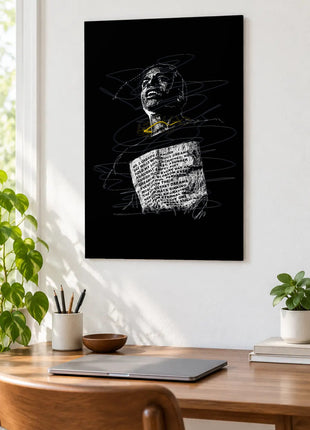 Words Across the Chest acrylic wall art displayed above a wooden desk with a laptop, plants and books against a white wall.