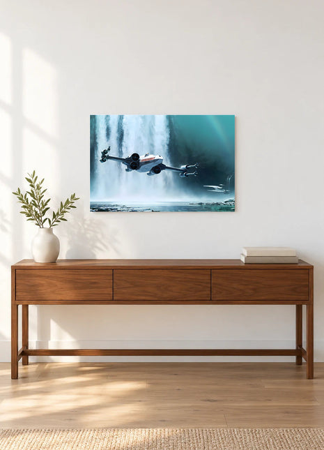 X-Wing Waterfall Run acrylic wall art displayed above a wooden console with a leafy vase and stacked books against a white wall.
