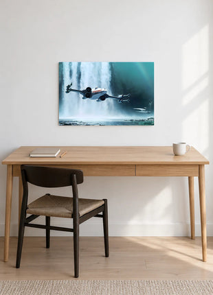 X-Wing Waterfall Run acrylic wall art displayed above a wooden desk with a notebook, pencil and white mug against a white wall.